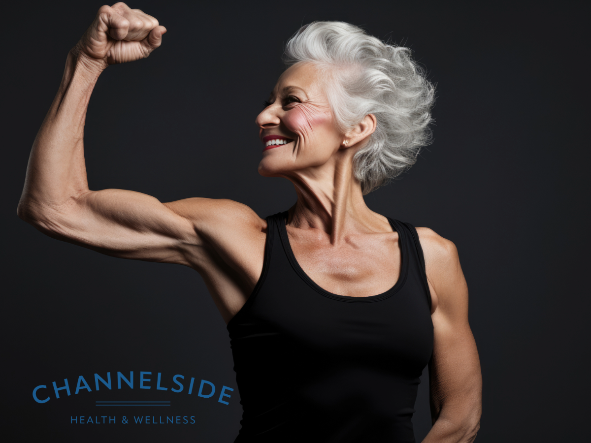 muscle health-woman with gray hair flexing muscles.