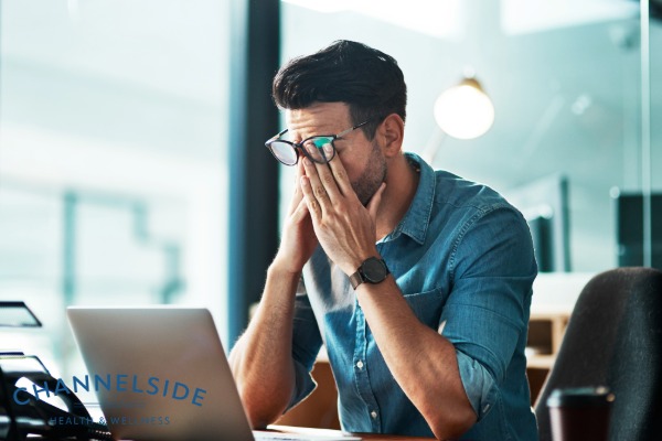 Reduce testosterone in aging men - tired man at a desk.