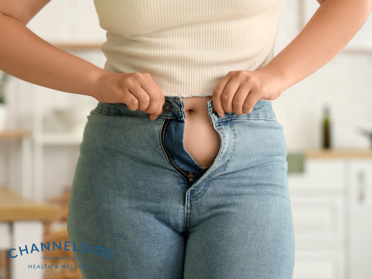 Perimenopause weight gain a woman having trouble fitting into jeans